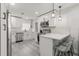 Contemporary kitchen boasts stainless steel appliances, crisp white cabinets, and bar seating at 13 Fanfair Ave, Orlando, FL 32811