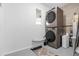 Convenient laundry room with stacked washer and dryer units, offering space-saving efficiency at 13 Fanfair Ave, Orlando, FL 32811