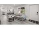 Inviting living area with light, modern flooring and a peek into the adjoining kitchen space at 13 Fanfair Ave, Orlando, FL 32811