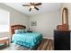 Cozy bedroom featuring a ceiling fan and wood-look flooring, providing a relaxing space at 1300 Island Green St, Davenport, FL 33896