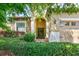 Inviting home exterior with a stone facade and lush green landscaping at 1300 Island Green St, Davenport, FL 33896