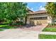 Beautiful home exterior with a red brick driveway and well-manicured landscaping at 1300 Island Green St, Davenport, FL 33896