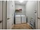 Functional laundry room equipped with a washer, dryer, and shelving for storage at 1300 Island Green St, Davenport, FL 33896