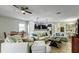 Spacious living room featuring tile flooring, ceiling fan, and large sofas at 1300 Island Green St, Davenport, FL 33896
