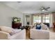 Bright and airy living room with comfortable seating and large windows at 1300 Island Green St, Davenport, FL 33896