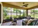 Relaxing screened patio with comfortable seating and views of the backyard at 1300 Island Green St, Davenport, FL 33896