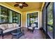 Relaxing screened-in patio featuring brick pavers, stylish furniture, and a ceiling fan for outdoor comfort at 1300 Island Green St, Davenport, FL 33896