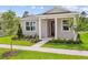 Charming single-story home with manicured lawn, landscaped garden beds, and inviting covered entry with white columns at 13082 Pergola Ave, Orlando, FL 32832