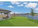 Backyard with a lush lawn, view of a lake, playset, trampoline, and patio with outdoor seating at 1312 Axel Graeson Ave, Kissimmee, FL 34744
