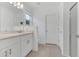 Bright bathroom featuring a double sink vanity, neutral tile flooring, and a glass-enclosed shower at 1312 Axel Graeson Ave, Kissimmee, FL 34744