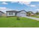 Well maintained one-story house featuring a lovely front lawn and attached garage at 1312 Axel Graeson Ave, Kissimmee, FL 34744