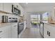 Well-lit kitchen with white cabinets, stainless steel appliances, and sliding doors to the backyard at 1312 Axel Graeson Ave, Kissimmee, FL 34744