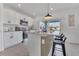 Modern kitchen with white cabinets, stainless steel appliances, and a central island with bar stools at 1312 Axel Graeson Ave, Kissimmee, FL 34744