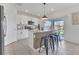 Contemporary kitchen with white cabinetry, modern appliances, island with seating, and sliding doors at 1312 Axel Graeson Ave, Kissimmee, FL 34744