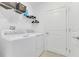 A laundry room featuring a white washer and dryer with overhead storage shelving at 1312 Axel Graeson Ave, Kissimmee, FL 34744