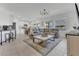 Inviting open-concept living area featuring sectional sofa, modern lighting, and ample light at 1312 Axel Graeson Ave, Kissimmee, FL 34744