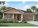 Charming single-Gathering home featuring a covered front porch and a two-car garage at 13248 Pergola Ave, Orlando, FL 32832