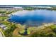 An aerial view of a lake with private docks surrounded by a residential neighborhood at 13299 Serene Valley Dr, Clermont, FL 34711