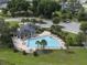 Aerial view of community pool, surrounded by green spaces and parking at 13299 Serene Valley Dr, Clermont, FL 34711