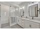 Elegant bathroom featuring double sinks, quartz countertops, and a modern glass shower at 13299 Serene Valley Dr, Clermont, FL 34711