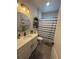 Well-lit bathroom featuring a decorative shower curtain, plants, and an attractive vanity mirror at 13299 Serene Valley Dr, Clermont, FL 34711