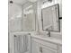 Bright bathroom showcasing a glass-enclosed shower and modern vanity with stone countertop at 13299 Serene Valley Dr, Clermont, FL 34711