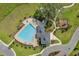 Aerial view of a community pool with a playground and seating at 13299 Serene Valley Dr, Clermont, FL 34711