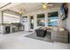 Covered patio with outdoor kitchen and a comfortable seating area, perfect for relaxation at 13299 Serene Valley Dr, Clermont, FL 34711