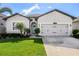 Charming single-story home with a well-manicured lawn and inviting curb appeal at 13299 Serene Valley Dr, Clermont, FL 34711