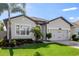 Beautiful curb appeal with a manicured lawn and fresh landscaping at 13299 Serene Valley Dr, Clermont, FL 34711