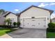 Garage and well-manicured lawn create an inviting curb appeal at 13299 Serene Valley Dr, Clermont, FL 34711