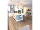 Bright kitchen featuring a large central island with barstool seating and modern pendant lighting at 13299 Serene Valley Dr, Clermont, FL 34711