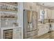 Modern kitchen featuring stainless steel refrigerator and a wine refrigerator, plus stylish shelving at 13299 Serene Valley Dr, Clermont, FL 34711