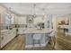 Well-equipped kitchen with sleek countertops, modern fixtures, white cabinetry, and an island at 13299 Serene Valley Dr, Clermont, FL 34711