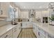 Gourmet kitchen featuring stainless steel appliances, white cabinets, and ample counter space at 13299 Serene Valley Dr, Clermont, FL 34711