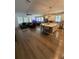 Expansive living area boasts an open floor plan, wood floors, and abundant natural light at 13299 Serene Valley Dr, Clermont, FL 34711