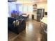 Open-concept living room with modern furnishings and bar, seamlessly connecting to the kitchen and dining areas at 13299 Serene Valley Dr, Clermont, FL 34711