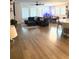Open-concept living room with modern furnishings, seamlessly connecting to the kitchen and dining areas at 13299 Serene Valley Dr, Clermont, FL 34711