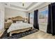 Comfortable main bedroom with tray ceiling, large windows, and natural light at 13299 Serene Valley Dr, Clermont, FL 34711