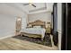 Comfortable bedroom featuring a tray ceiling, a ceiling fan, and natural lighting at 13299 Serene Valley Dr, Clermont, FL 34711