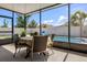 Screened patio featuring outdoor dining area with views of the pool and backyard at 13299 Serene Valley Dr, Clermont, FL 34711