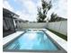 Backyard oasis featuring a refreshing pool, clean landscaping, and a privacy fence at 13299 Serene Valley Dr, Clermont, FL 34711
