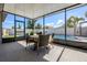 The screened-in patio features a table with seating for four, overlooking the backyard pool area at 13299 Serene Valley Dr, Clermont, FL 34711