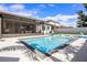 This backyard features a sparkling swimming pool and a covered patio area at 13299 Serene Valley Dr, Clermont, FL 34711