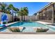 Sparkling backyard swimming pool with lounge chairs in the water and a covered patio at 13299 Serene Valley Dr, Clermont, FL 34711