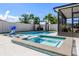 Backyard featuring a sparkling swimming pool, a relaxing jacuzzi, and a basketball hoop at 13299 Serene Valley Dr, Clermont, FL 34711