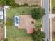 Aerial view of home with screened pool, mature trees, and sidewalk at 1441 Olde Kensington Ln, Deltona, FL 32725