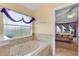 Bathroom with a large tub and a view to the main bedroom at 1441 Olde Kensington Ln, Deltona, FL 32725