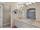 Bright bathroom featuring a double vanity and walk-in shower with glass doors at 1441 Olde Kensington Ln, Deltona, FL 32725