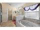 Bathroom featuring a soaking tub and a separate vanity at 1441 Olde Kensington Ln, Deltona, FL 32725